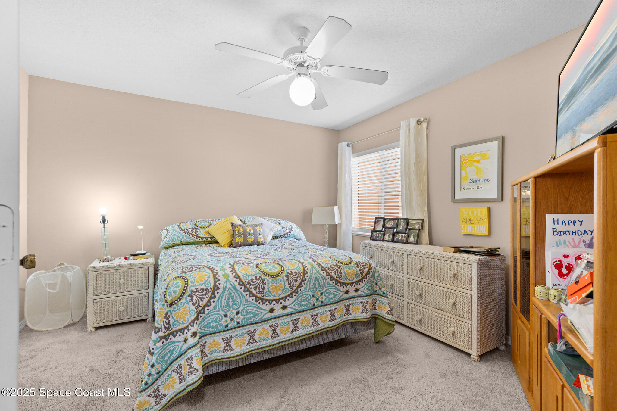 243 Forecast Lane, Unit 421 Rockledge, FL 32955 - Photo 9 of 43 a bedroom with a bed and a chandelier