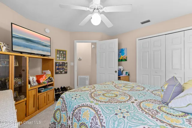 a bedroom that has a bed and a chandelier