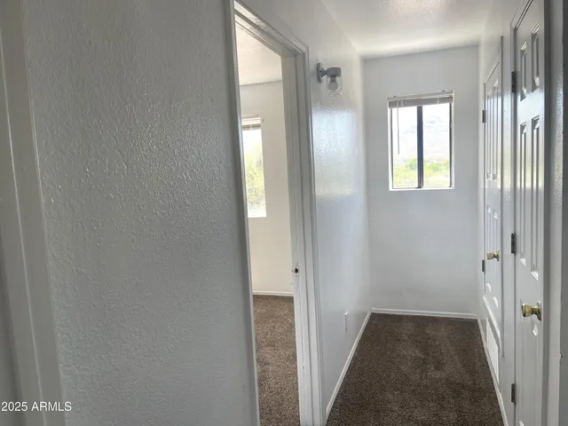 a view of a hallway with windows