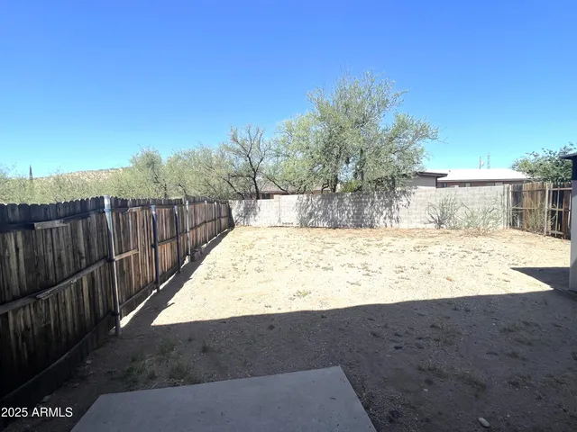a view of small yard with wooden fence
