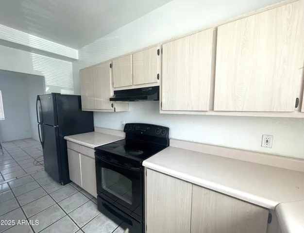 a kitchen with a stove and a refrigerator