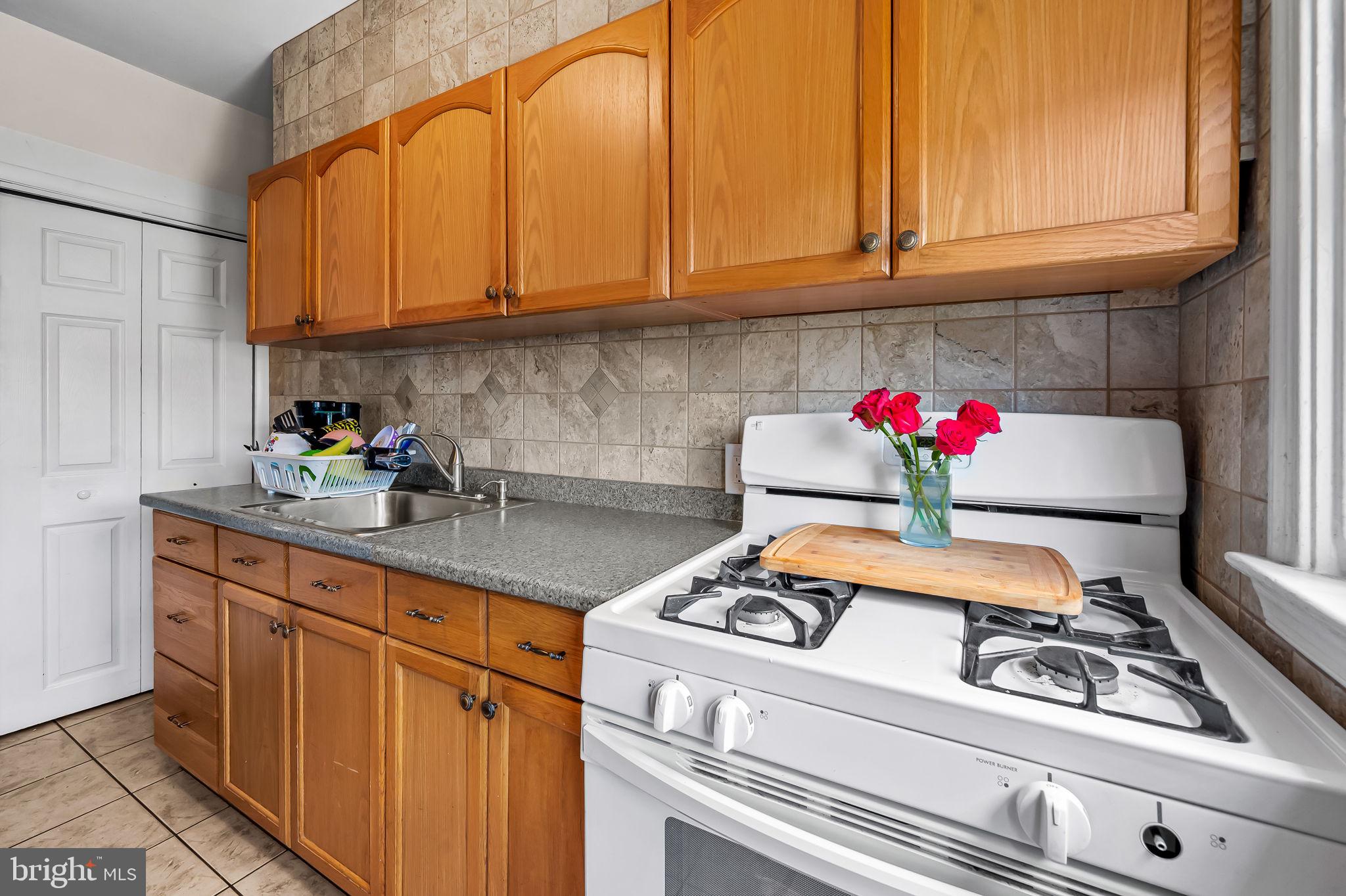 2855 Plainfield Road Baltimore, MD 21222 - Photo 11 of 27 a kitchen with stainless steel appliances granite countertop a sink dishwasher stove and cabinets