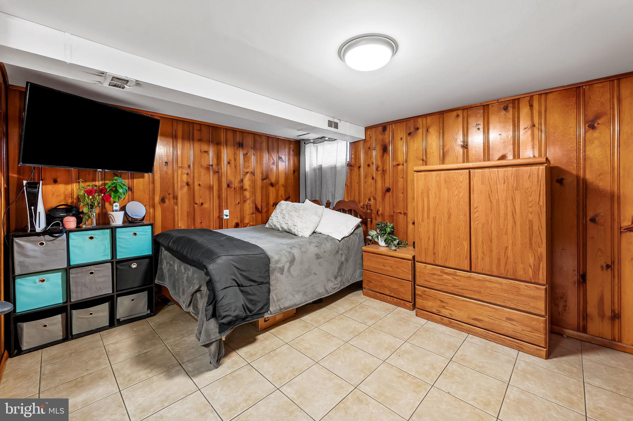 2855 Plainfield Road Baltimore, MD 21222 - Photo 20 of 27 a bedroom with a bed and a flat tv screen