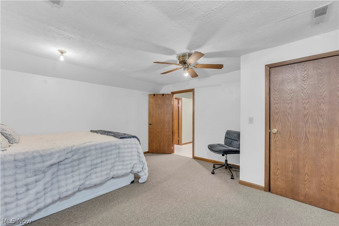 408 River Road Canal Fulton, OH 44614 - Photo 30 of 42 Carpeted room featuring a ceiling fan, recessed lighting, and wood-finish doors