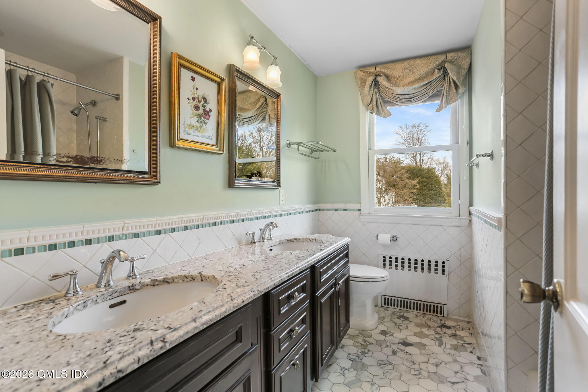 153 Lockwood Road Riverside, CT 06878 - Photo 33 of 58 a bathroom with a granite countertop sink and a window