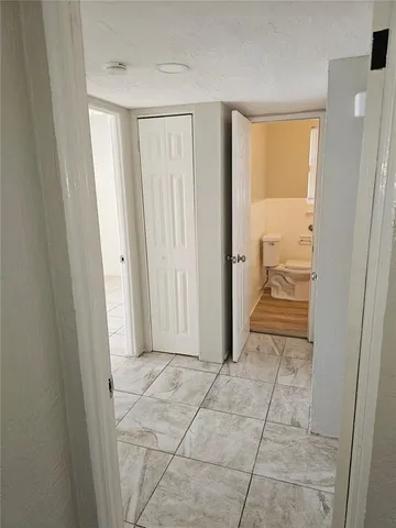 a bathroom with a sink and mirror with toilet