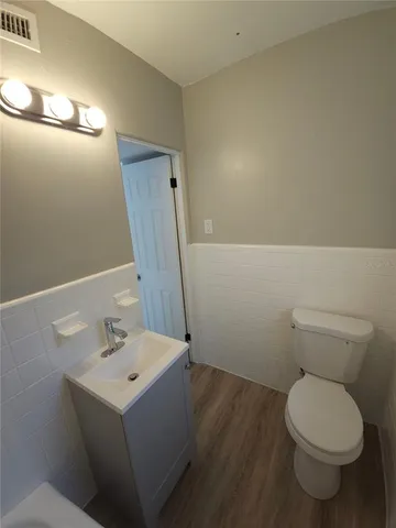 a kitchen with granite countertop a refrigerator and a stove top oven