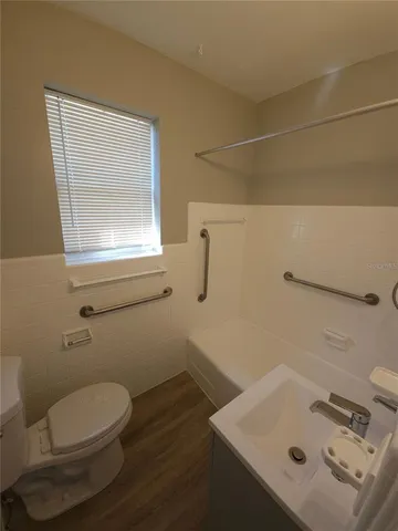 a kitchen with granite countertop a refrigerator and a sink