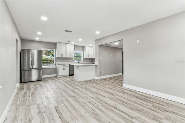 a kitchen with stainless steel appliances granite countertop a sink a stove and cabinets