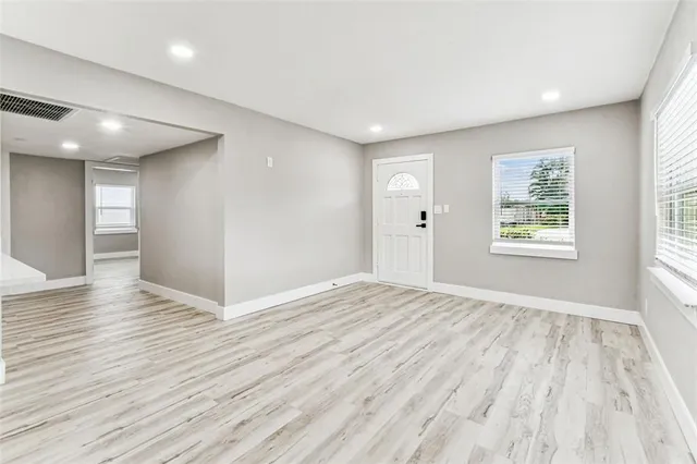 a kitchen with granite countertop white cabinets and stainless steel appliances