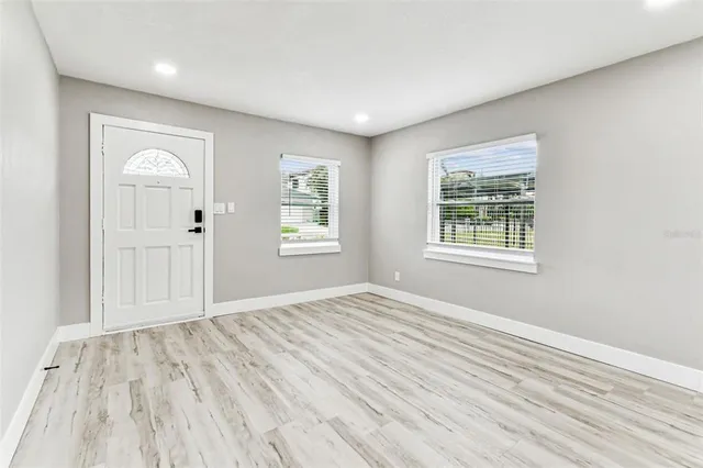 a kitchen with kitchen island a sink a counter space and cabinets