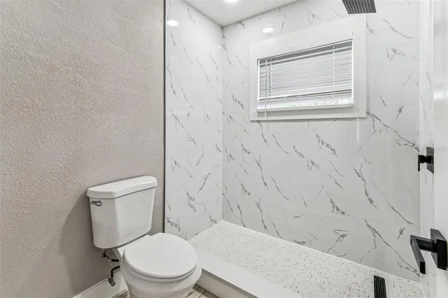 a view of a livingroom with wooden floor and a window