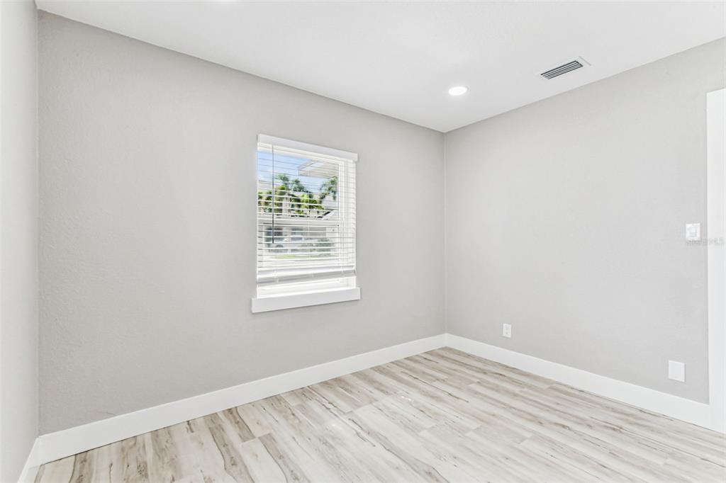 5 West Spanish Main Street Tampa, FL 33609 - Photo 27 of 72 an empty room with wooden floor and windows