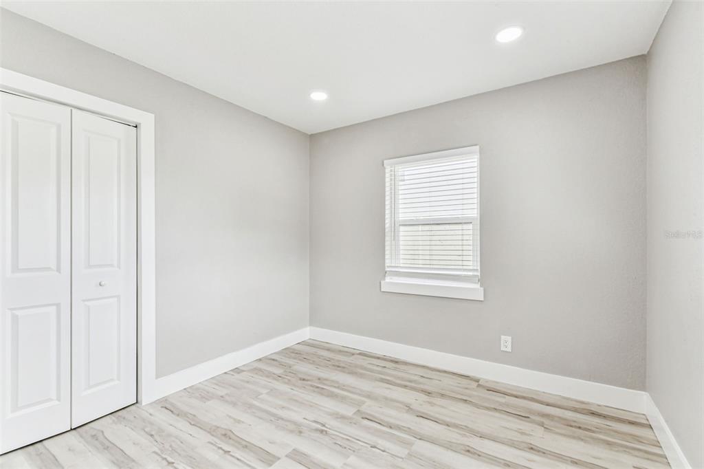 5 West Spanish Main Street Tampa, FL 33609 - Photo 29 of 72 an empty room with wooden floor and windows