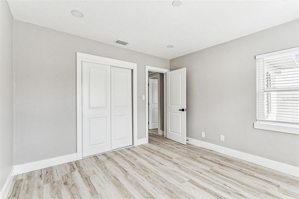 5 West Spanish Main Street Tampa, FL 33609 - Photo 32 of 72 an empty room with wooden floor and windows