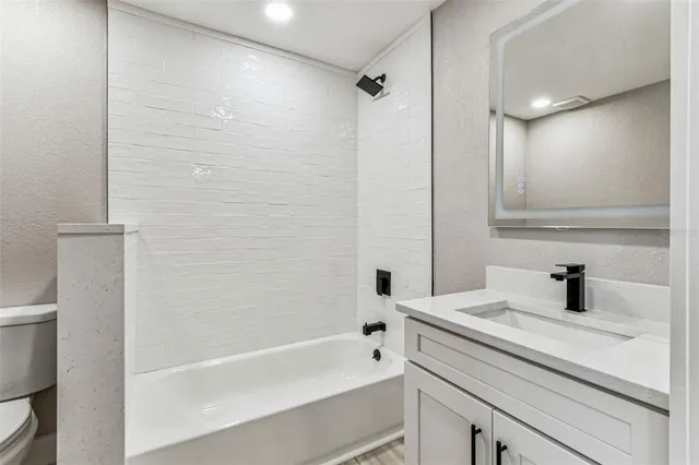 an aerial view of ocean and residential building with outdoor space