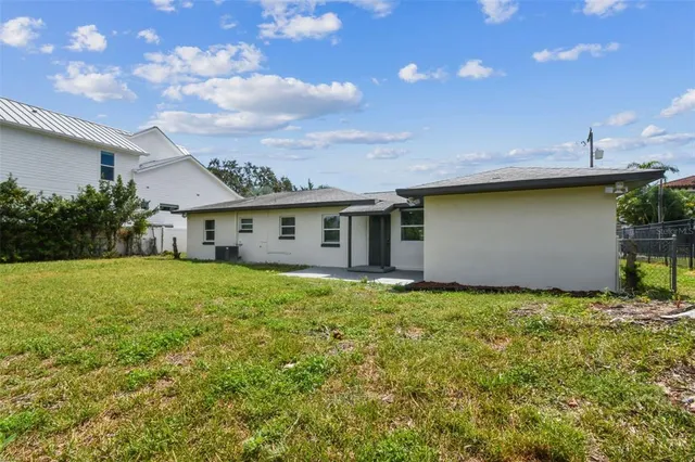 an aerial view of residential houses with outdoor space and lake view