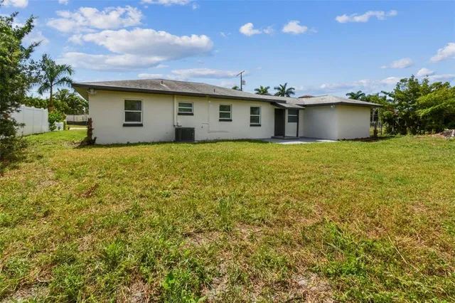 a aerial view of a house with big yard and large trees