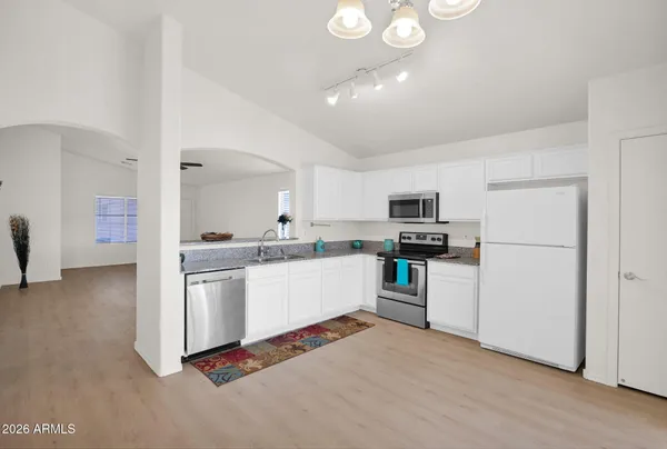 a kitchen with refrigerator and stove
