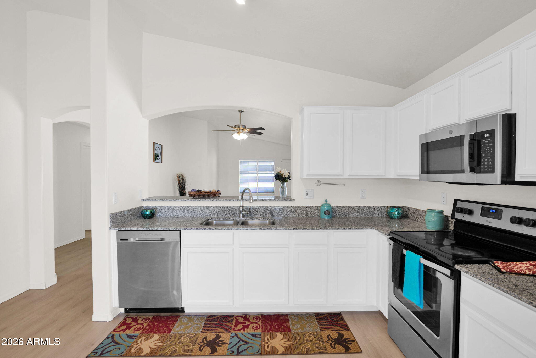 429 South Labelle Mesa, AZ 85208 - Photo 12 of 35 a kitchen with stainless steel appliances granite countertop a sink stove and microwave