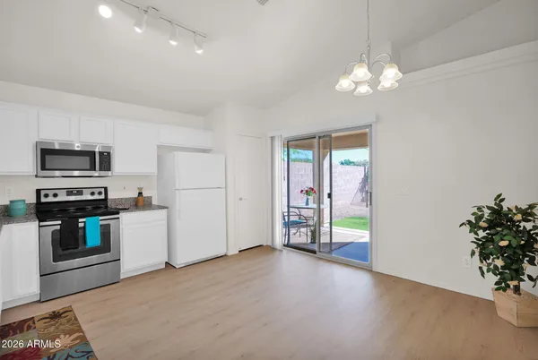 a view of a kitchen with a stove cabinets and a chandelier