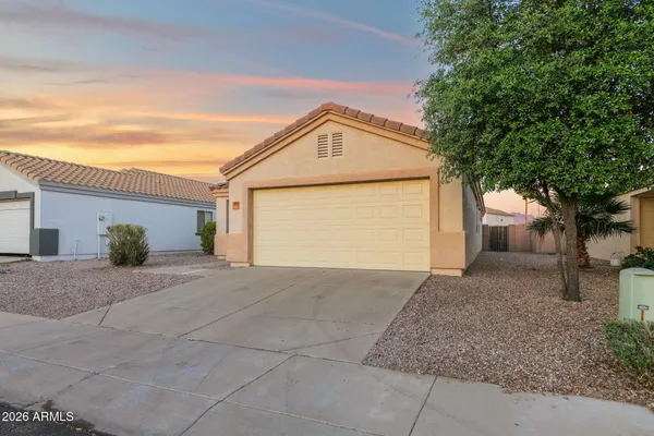 a view of a house with a yard and garage