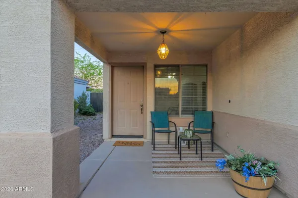 a view of a porch with a dining table and chairs