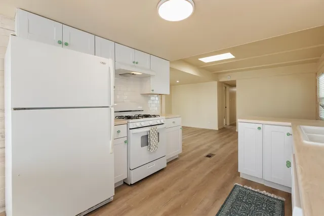a living room with a table and chairs next to a window