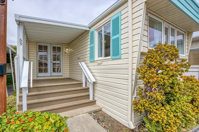 a view of a brick house with a door and a large window