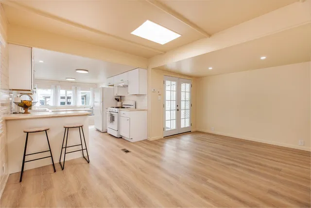 a room with natural light and wooden floor