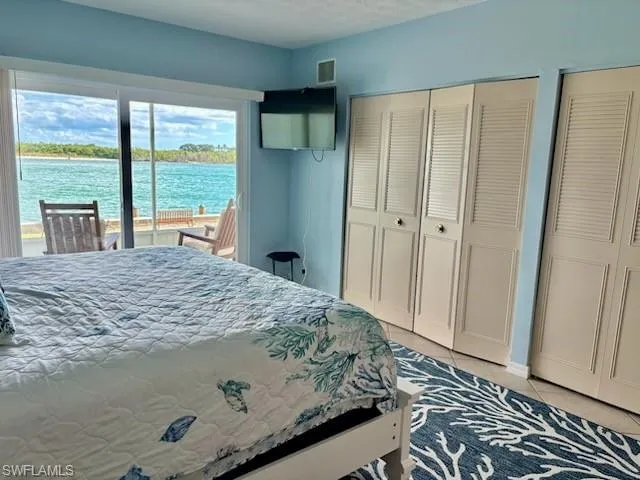 a bathroom with a granite countertop sink a toilet and a mirror