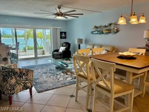 a living room with furniture a flat screen tv and a large window