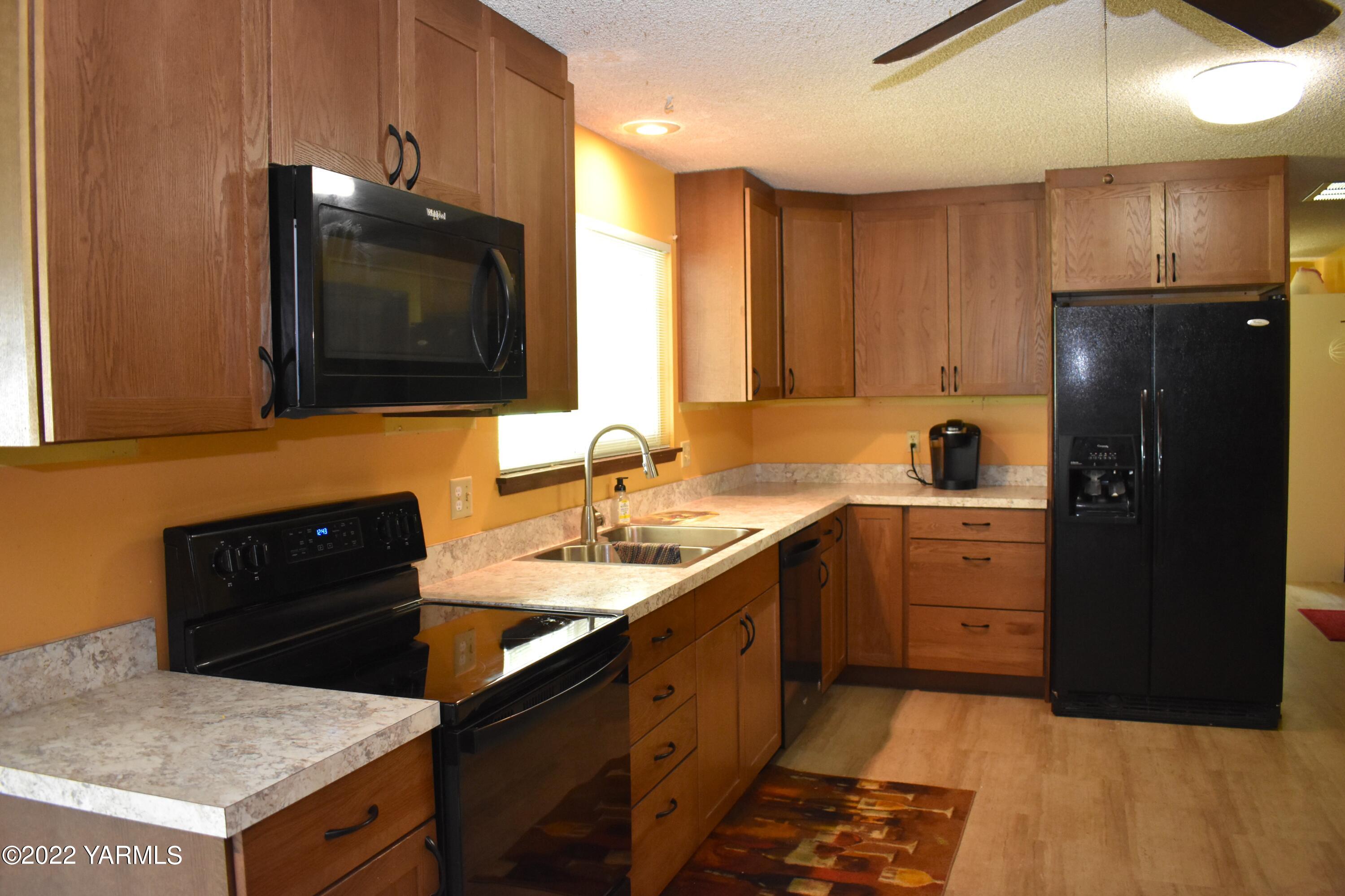 91 Elliott Road Cowiche, WA 98923 - Photo 11 of 46 a kitchen with a sink a stove and refrigerator