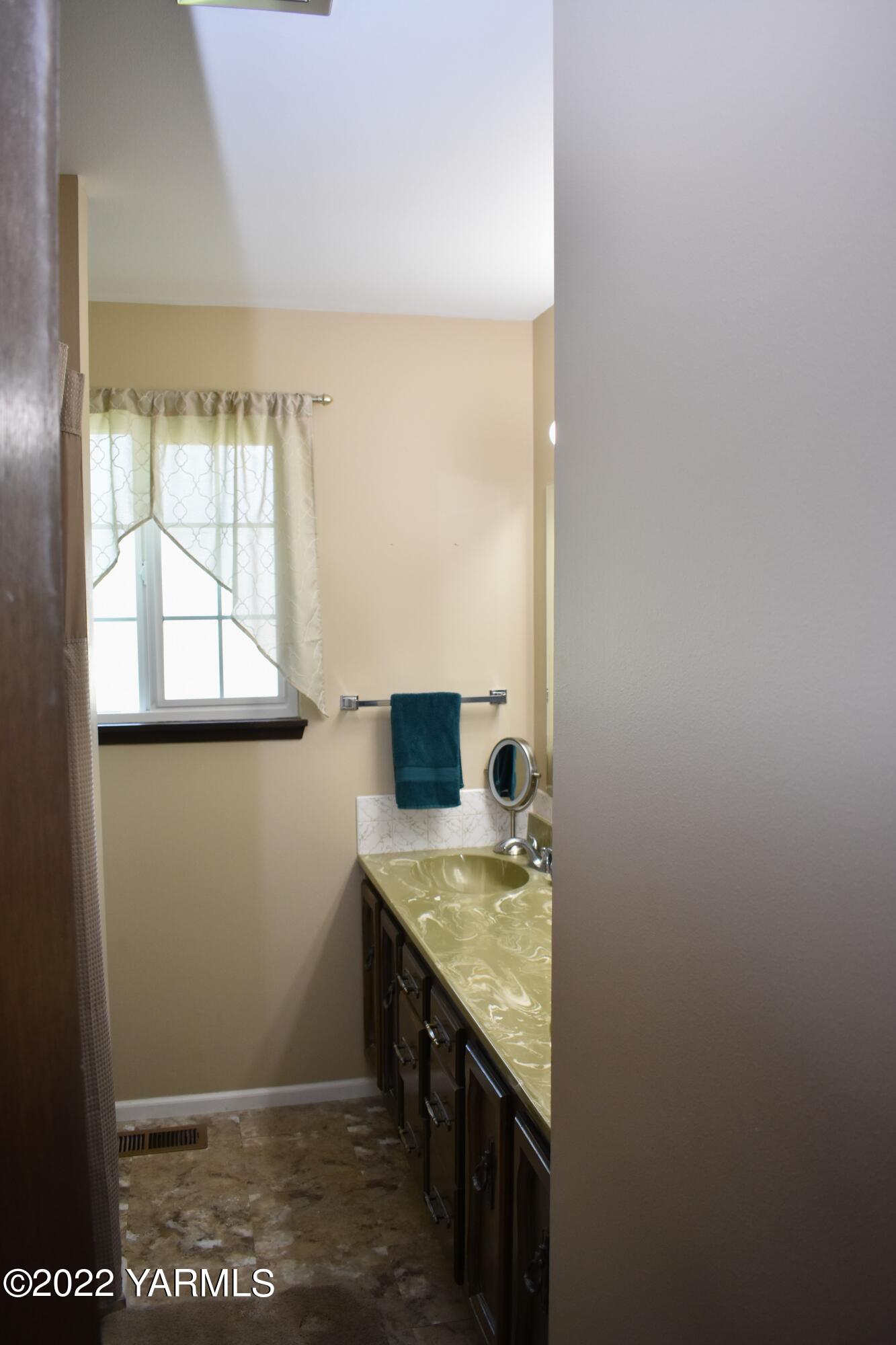 91 Elliott Road Cowiche, WA 98923 - Photo 26 of 46 a bathroom with a granite countertop sink and a window