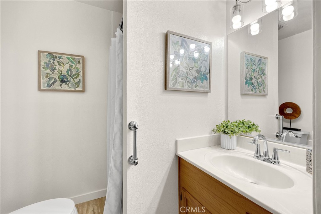 909 Orangewood Drive Brea, CA 92821 - Photo 11 of 19 a bathroom with a sink vanity mirror and toilet