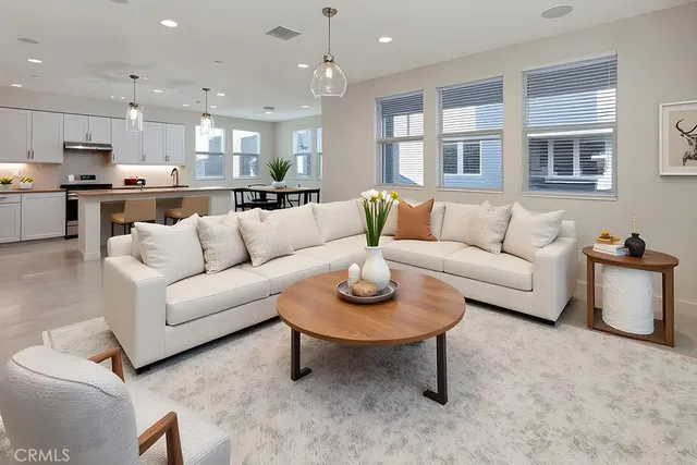 a living room with furniture and kitchen view