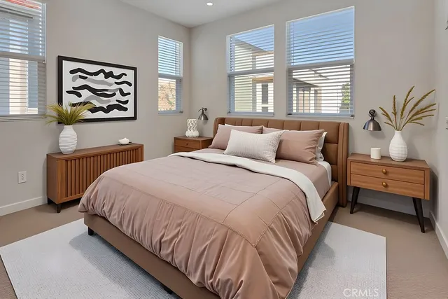 a bedroom with a large bed and a window