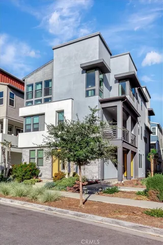 a front view of a building with a garden and plants