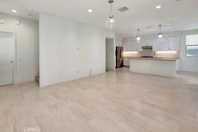a view of kitchen with kitchen island a sink appliances and a counter top space