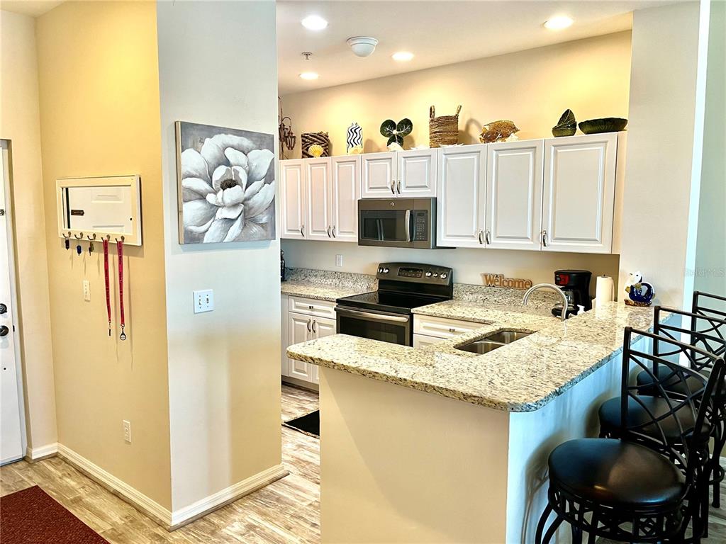 2090 Matecumbe Key Road, Unit 1705 Punta Gorda, FL 33955 - Photo 8 of 31 a kitchen with a refrigerator and a stove top oven