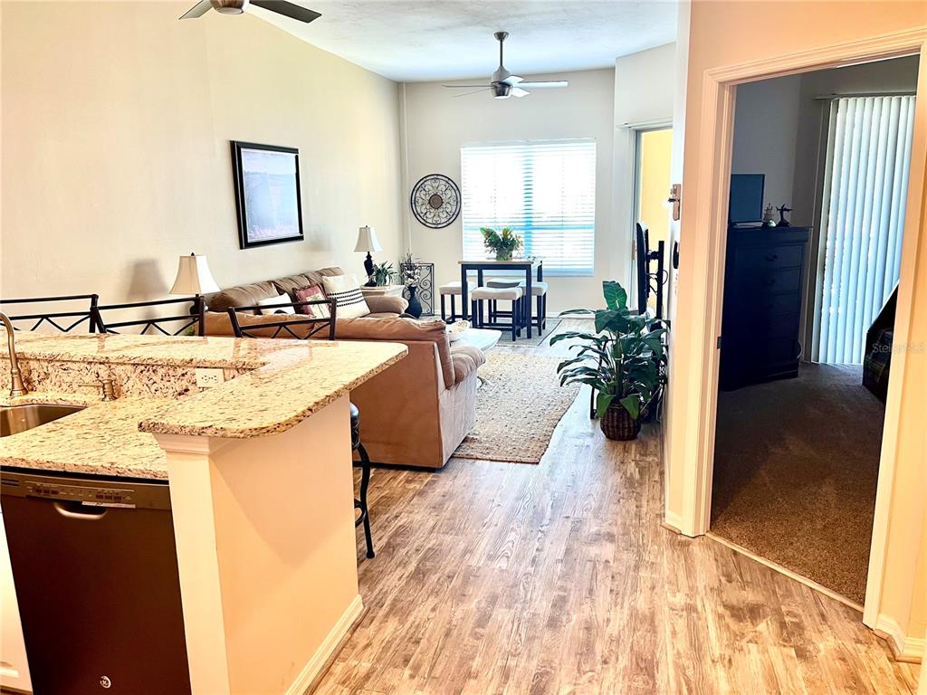 2090 Matecumbe Key Road, Unit 1705 Punta Gorda, FL 33955 - Photo 9 of 31 a living room with stainless steel appliances granite countertop furniture wooden floor and a window