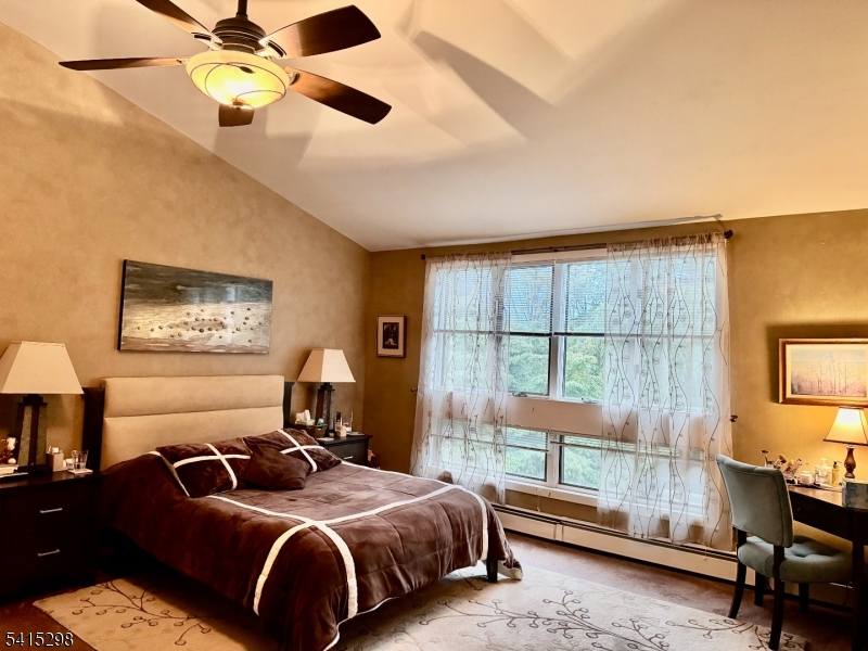 447 Rockaway Valley Road Boonton, NJ 07005 - Photo 14 of 29 a bedroom with a bed and a chandelier