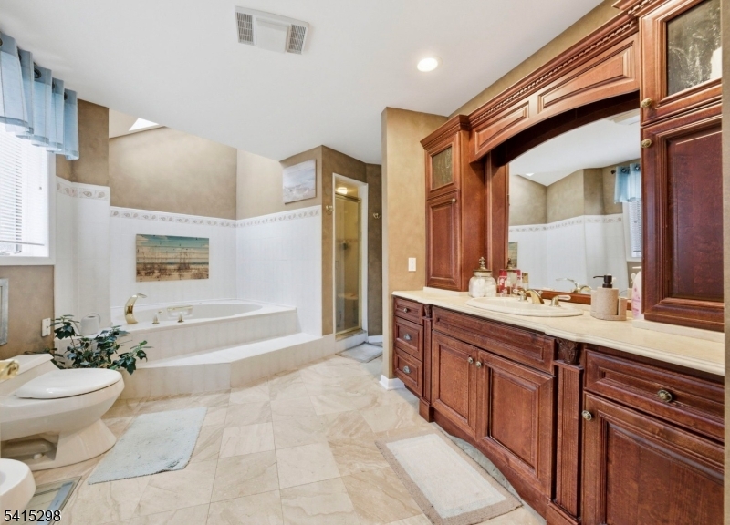 447 Rockaway Valley Road Boonton, NJ 07005 - Photo 15 of 29 a spacious bathroom with a bathtub shower sink mirror and toilet