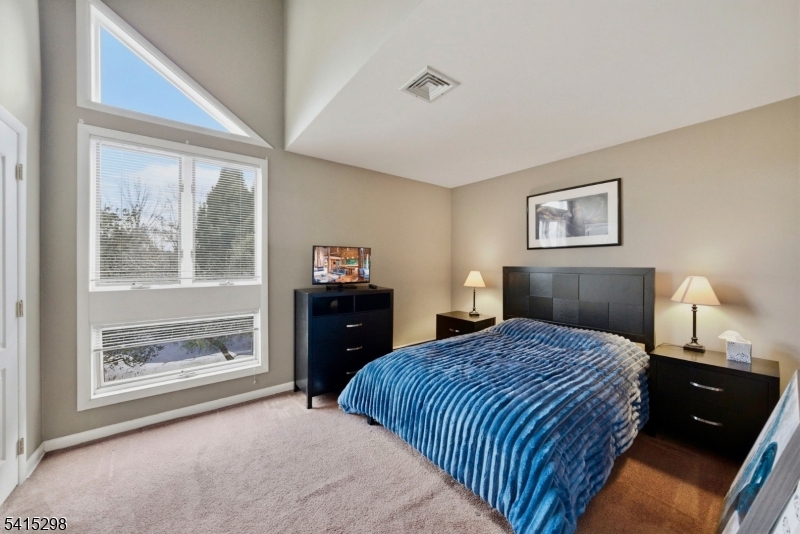 447 Rockaway Valley Road Boonton, NJ 07005 - Photo 16 of 29 a bedroom with a bed and a painting on the wall