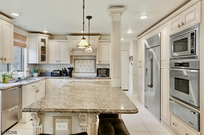 447 Rockaway Valley Road Boonton, NJ 07005 - Photo 10 of 29 a kitchen with stainless steel appliances granite countertop a stove refrigerator and cabinets