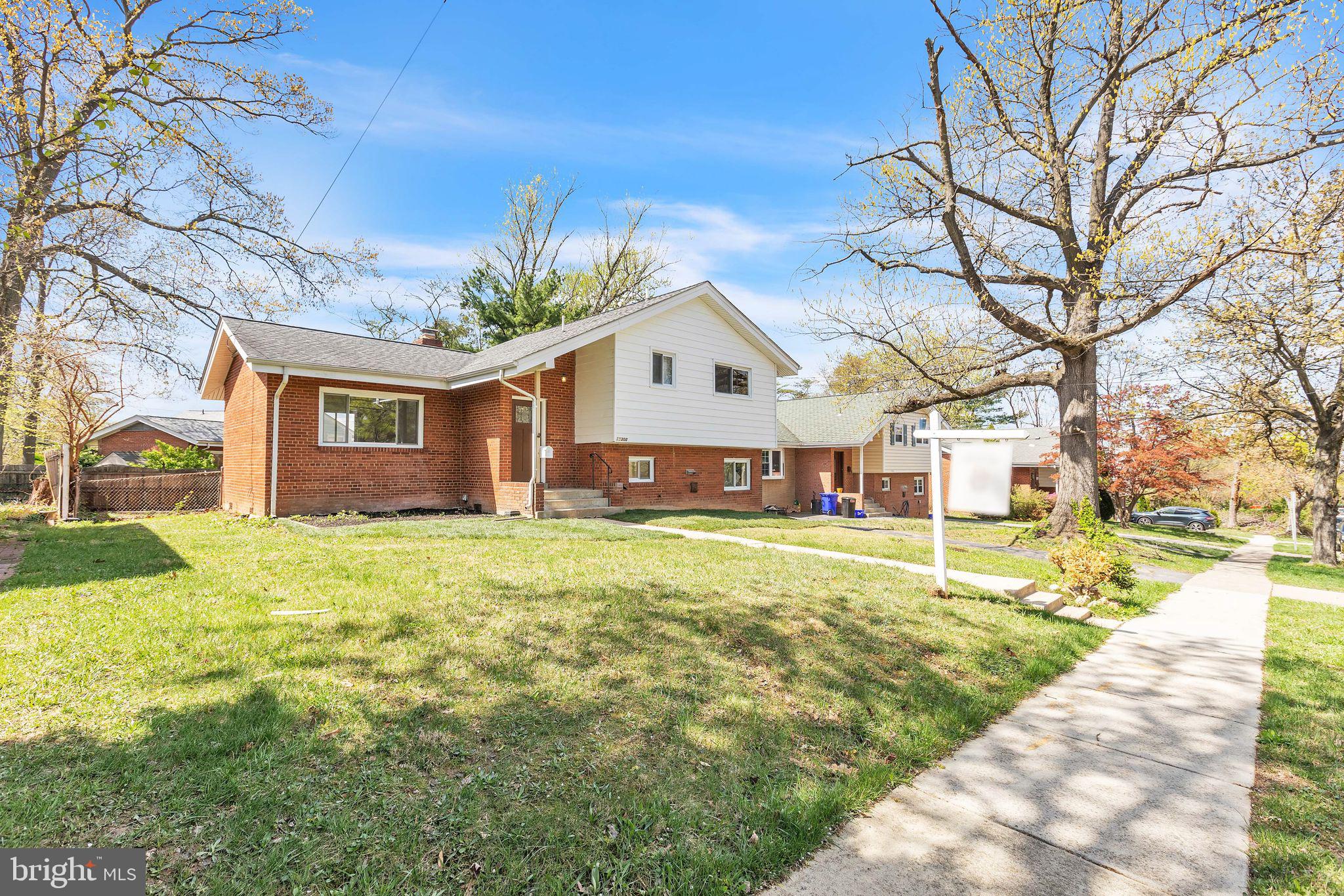 11308 Veirs Mill Road Silver Spring, MD 20902 - Photo 1 of 21 a front view of a house with a yard and garage