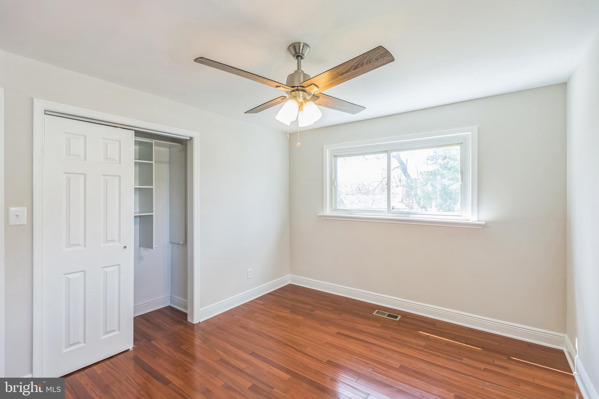 11308 Veirs Mill Road Silver Spring, MD 20902 - Photo 14 of 21 a view of a room with wooden floor and a ceiling fan