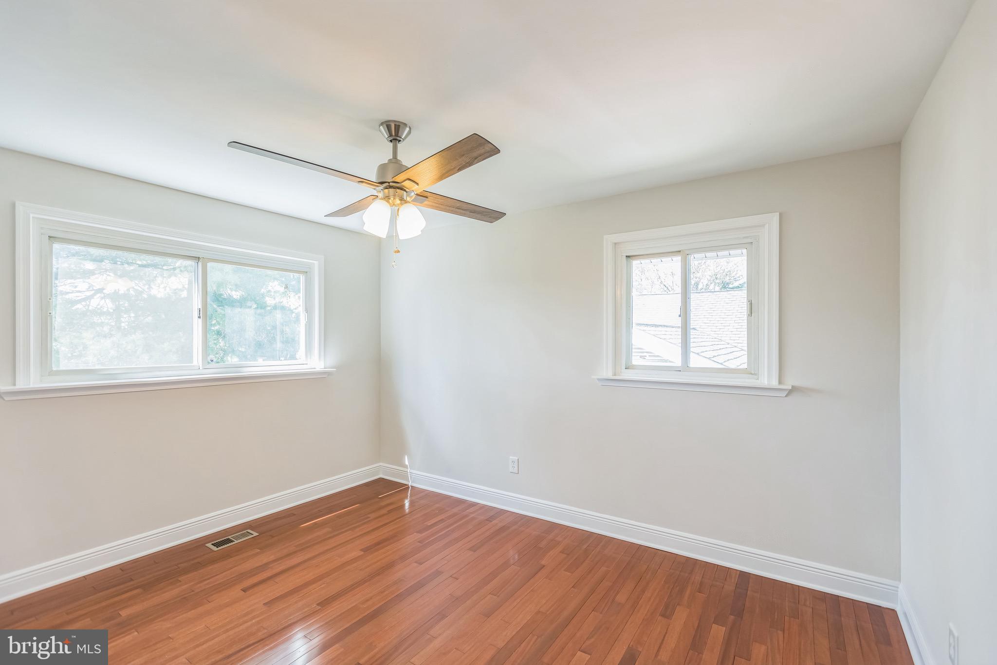 11308 Veirs Mill Road Silver Spring, MD 20902 - Photo 15 of 21 an empty room with wooden floor windows and fan