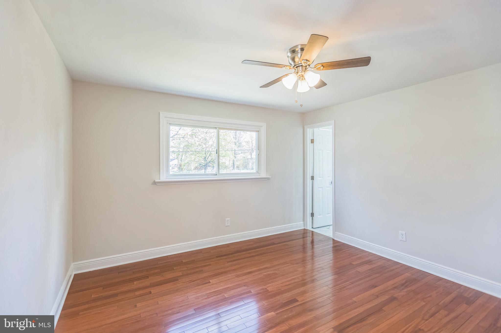 11308 Veirs Mill Road Silver Spring, MD 20902 - Photo 18 of 21 a view of an empty room with wooden floor and a window