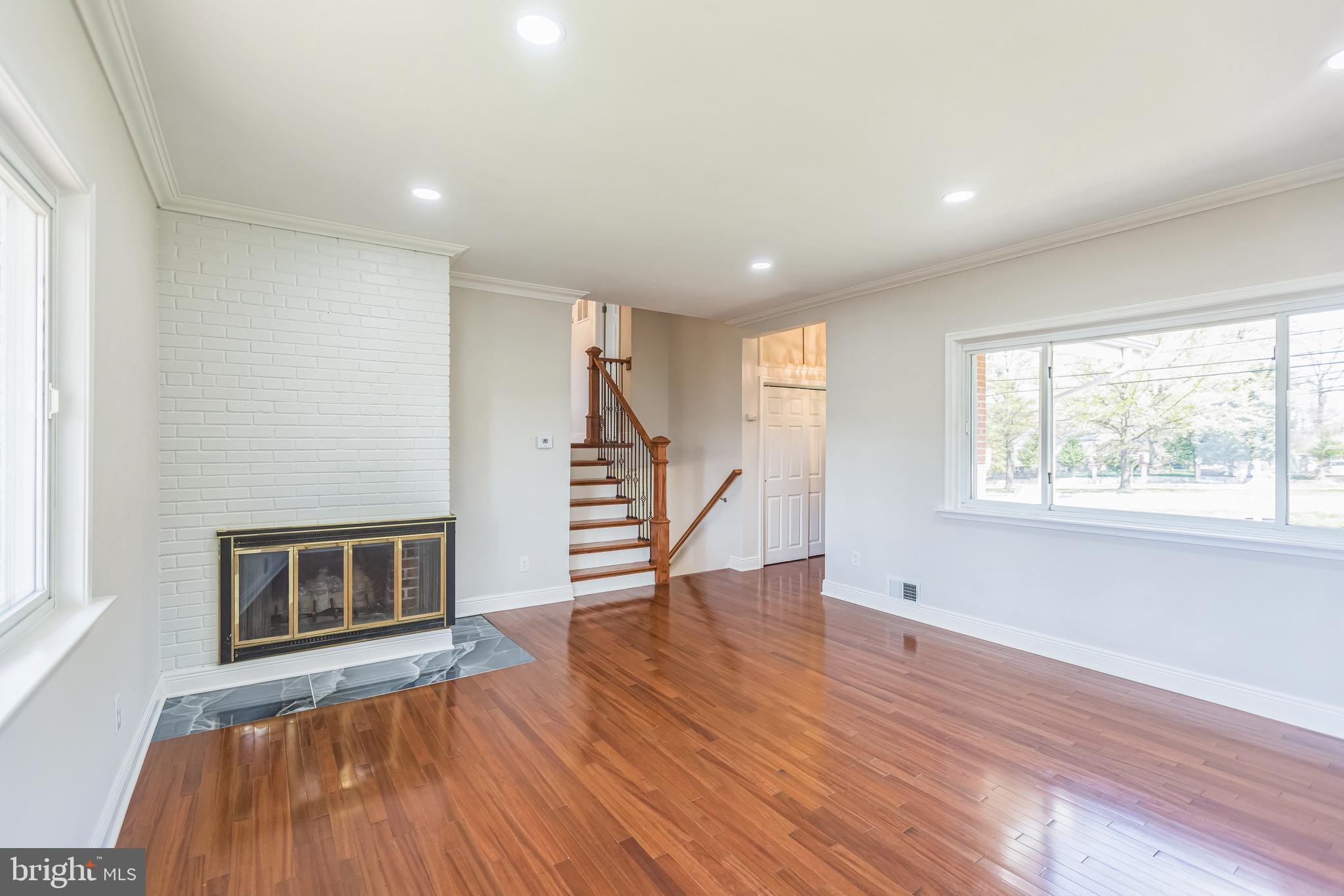 11308 Veirs Mill Road Silver Spring, MD 20902 - Photo 2 of 21 a view of an empty room with wooden floor fireplace and a window
